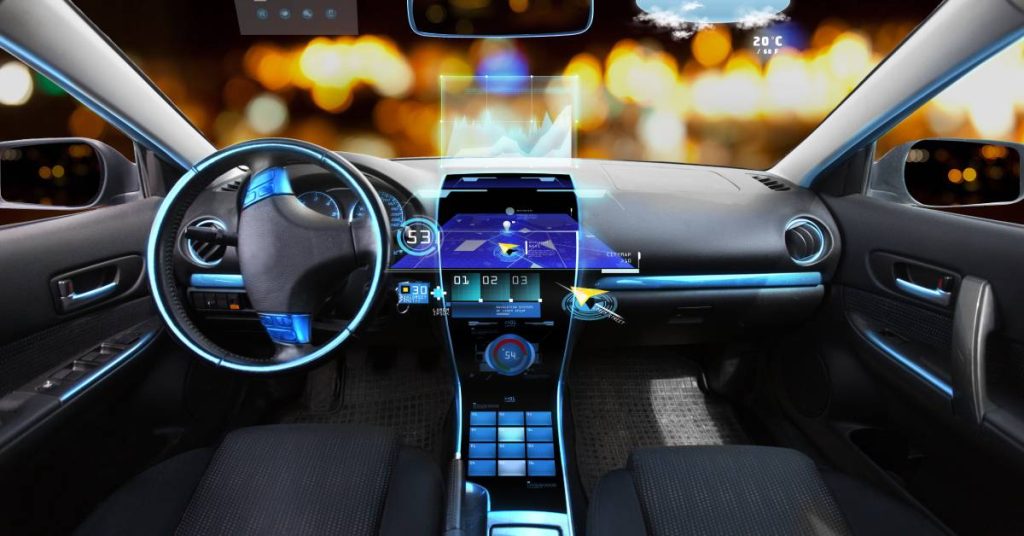 An interior shot of a small vehicle showing the navigation system and various sensors and other systems.